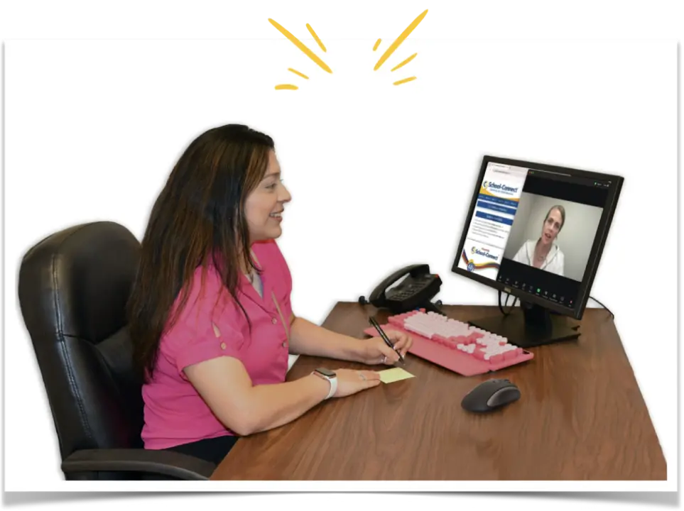 Teacher sitting at a desk, on a video chat with another teacher