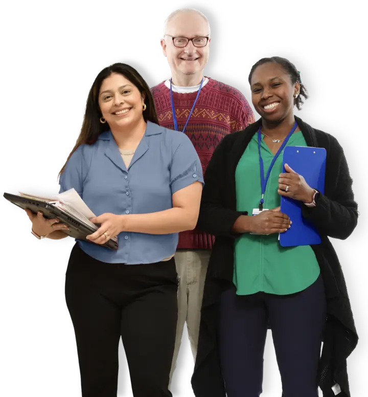 One male and two female teachers smiling and holding clipboards