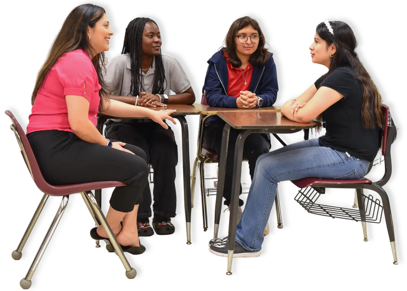 Teacher and three students sitting in desks and talking