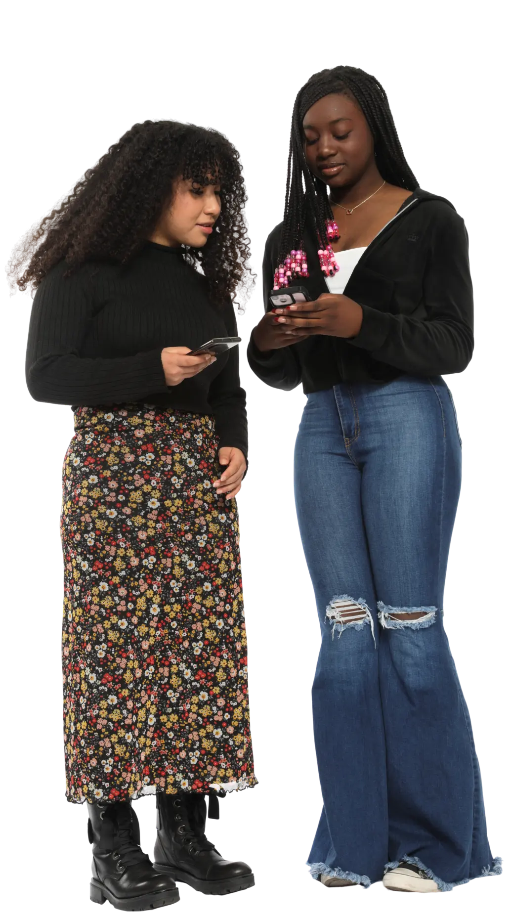 Two teen girls looking at their cell phones