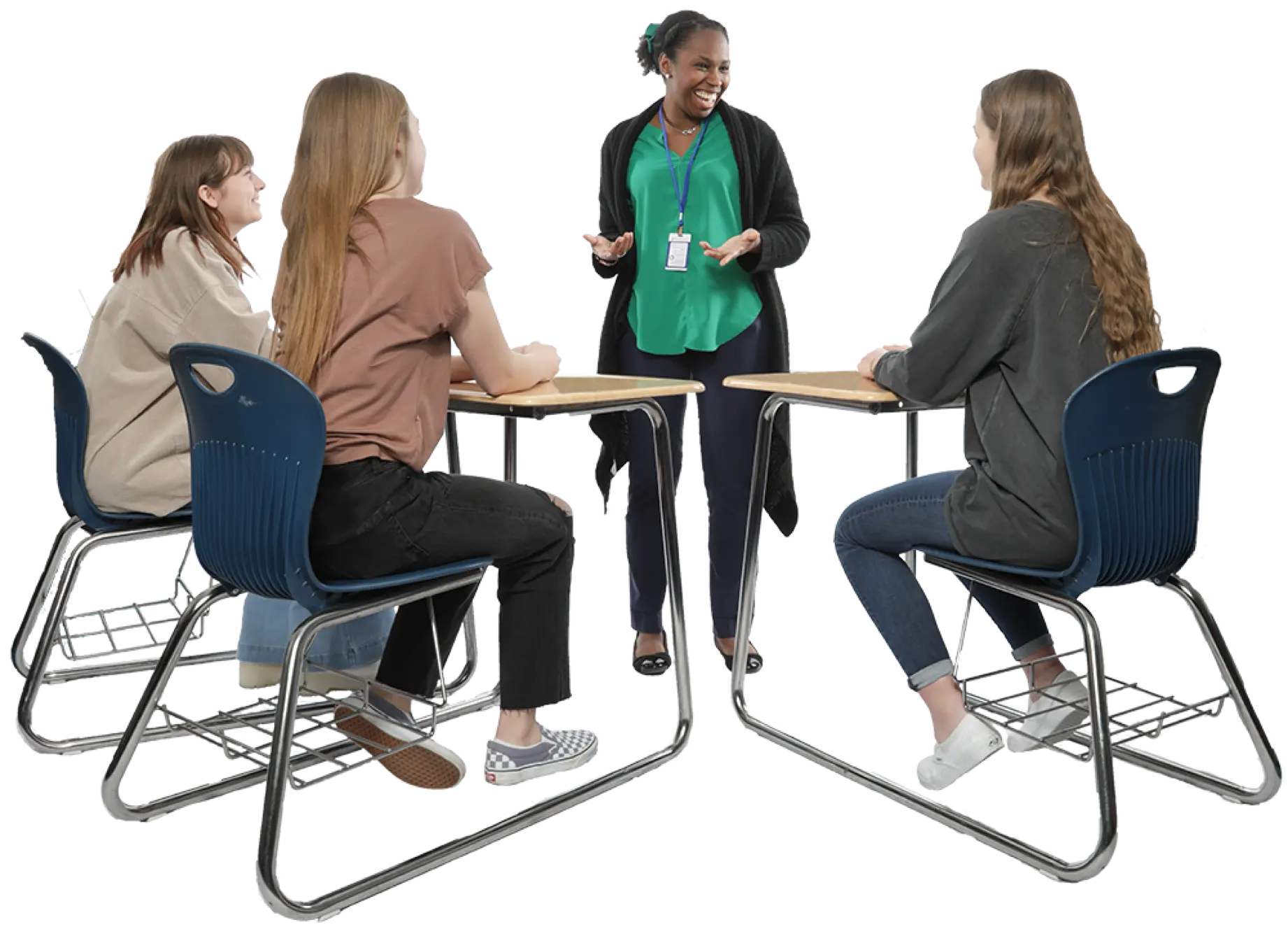 Teacher standing and talking to three students at their desks